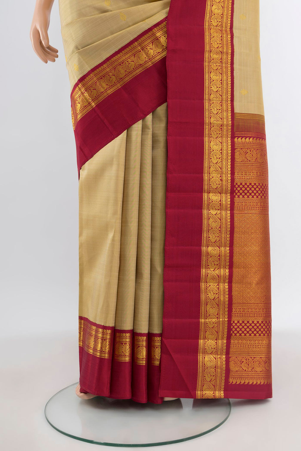 Pleats and pallu of Pure Silk Pure Zari Sandal Kanchipuram Saree with Zari Butta on the body and Zari Border. 