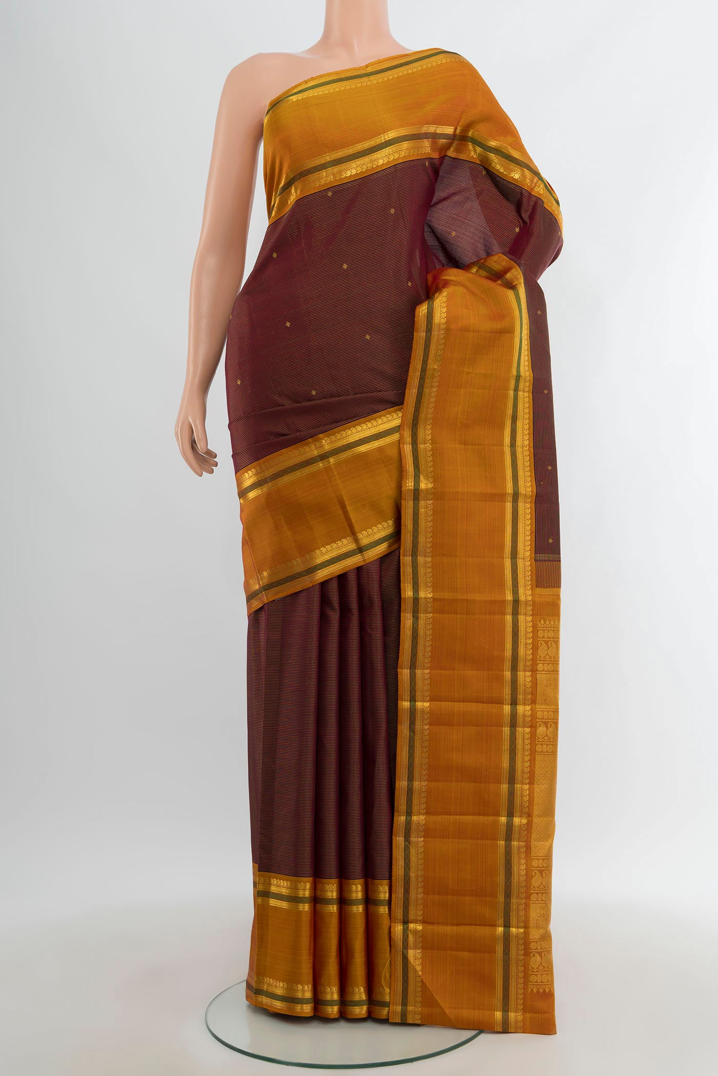 Pure Silk Pure Zari Maroon Kanchipuram Saree with Zari Brocade on the body and Zari Border.  displayed on a mannequin