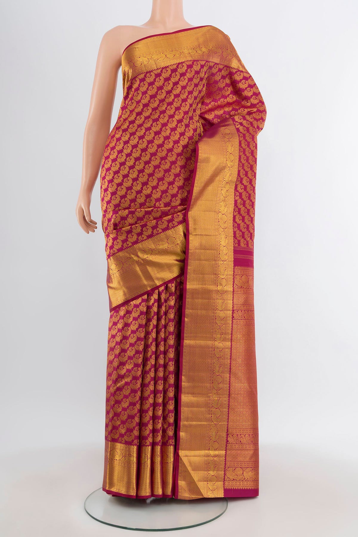 Magenta Kanchipuram Silk Saree with Zari Brocade on the body and Zari Border.  displayed on a mannequin