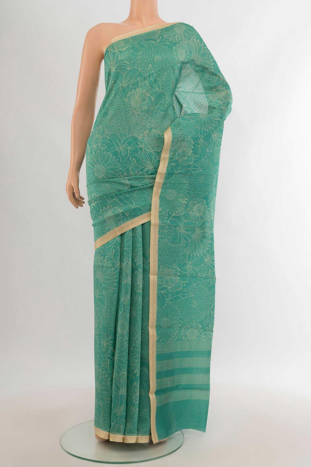 Sky Blue Tussar Silk Saree with Floral Print on the body and Zari Border.  displayed on a mannequin