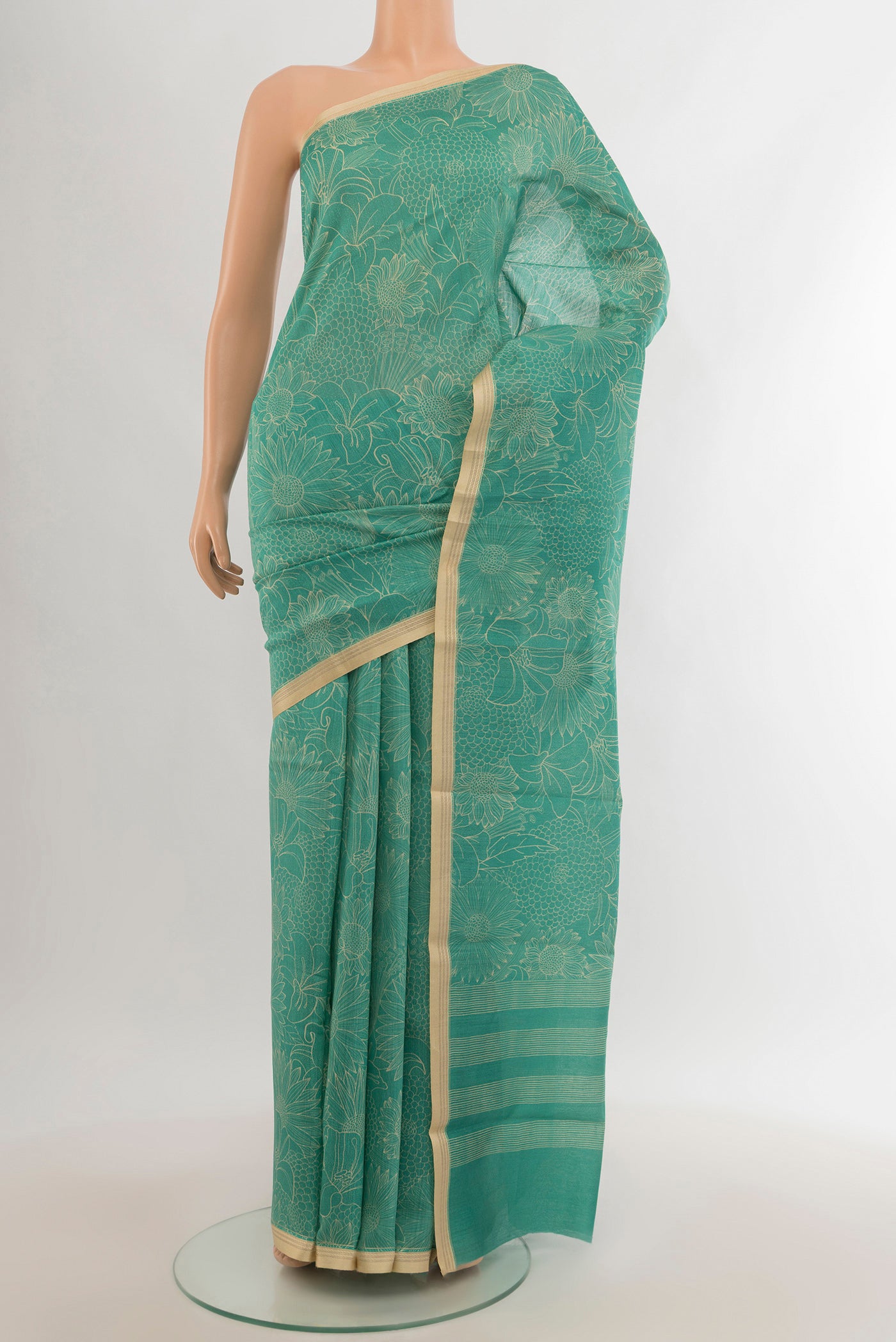 Sky Blue Tussar Silk Saree with Floral Print on the body and Zari Border.  displayed on a mannequin
