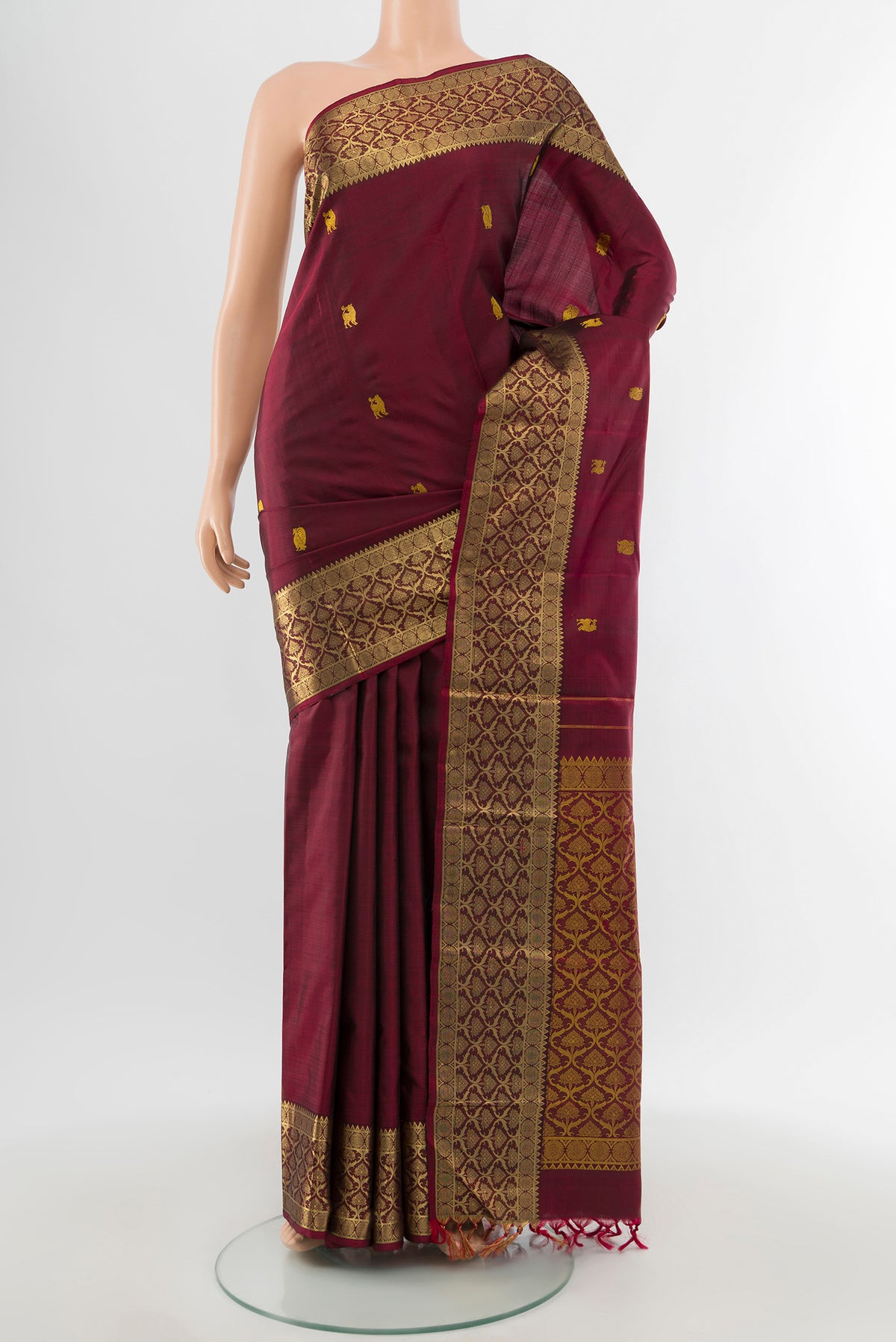 Maroon Kanjivaram Silk Saree with Thread Butta on the body and Zari Border.  displayed on a mannequin
