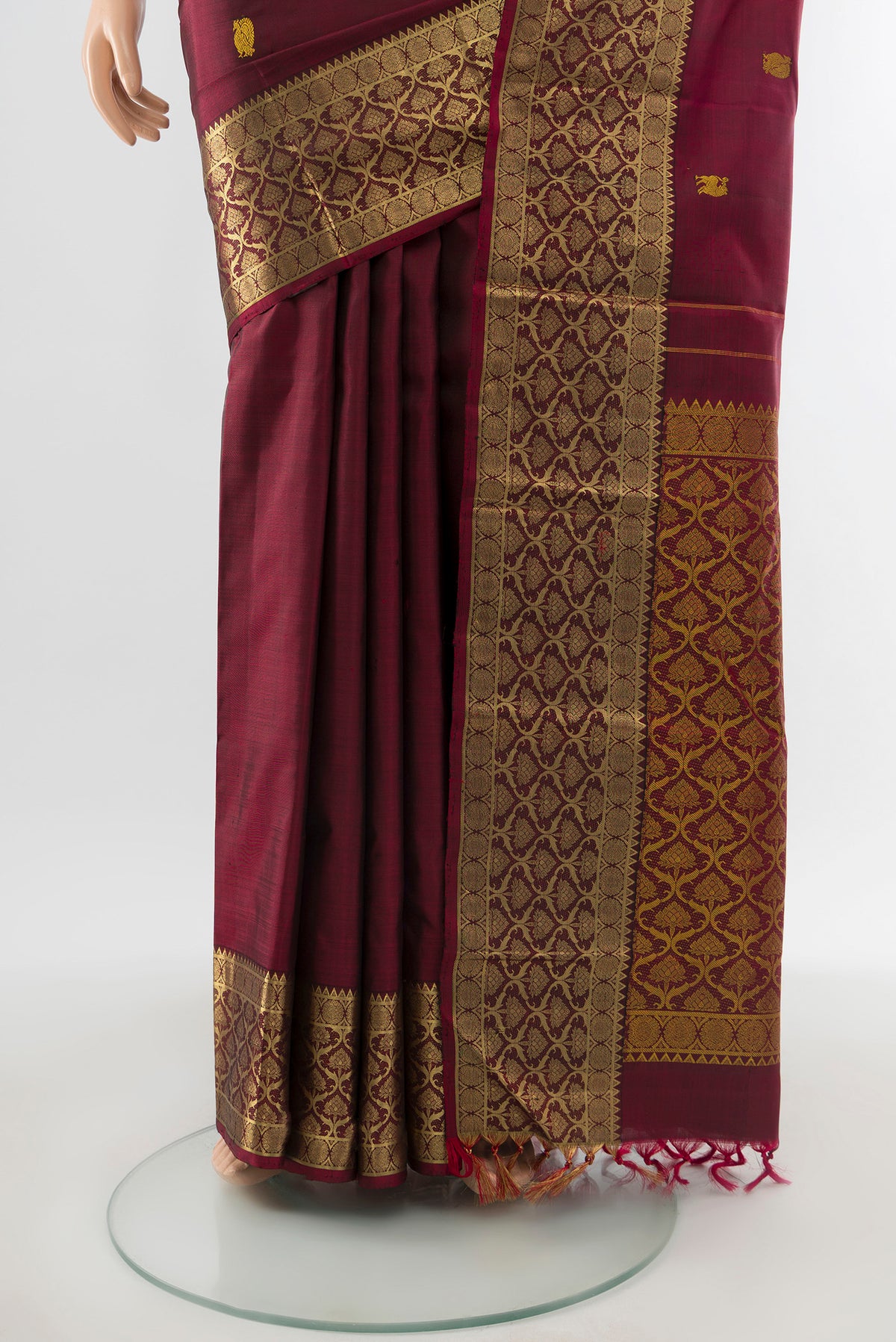 Pleats and pallu of Maroon Kanjivaram Silk Saree with Thread Butta on the body and Zari Border. 