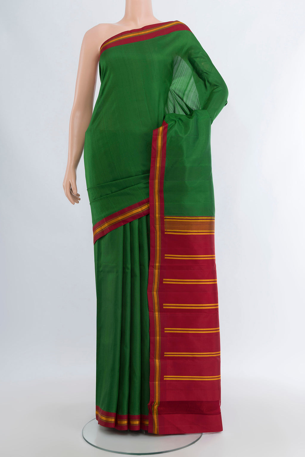 Green Kanjivaram Silk Saree with Plain Body and Thread Border.  displayed on a mannequin