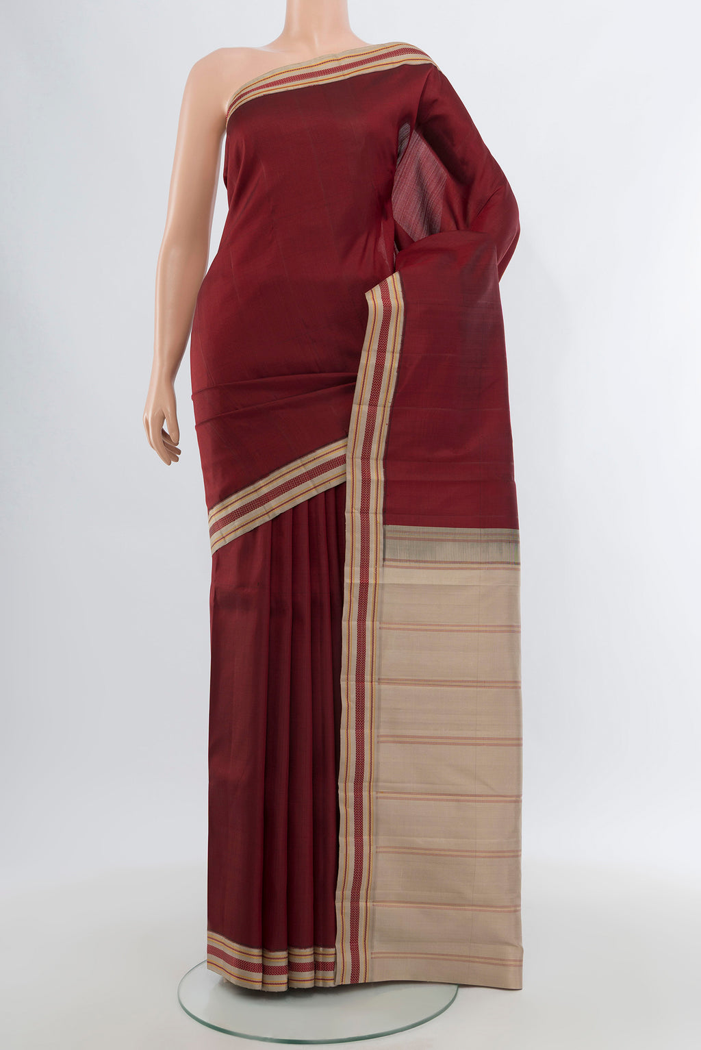 Maroon Kanjivaram Silk Saree with Plain Body and Thread Border.  displayed on a mannequin