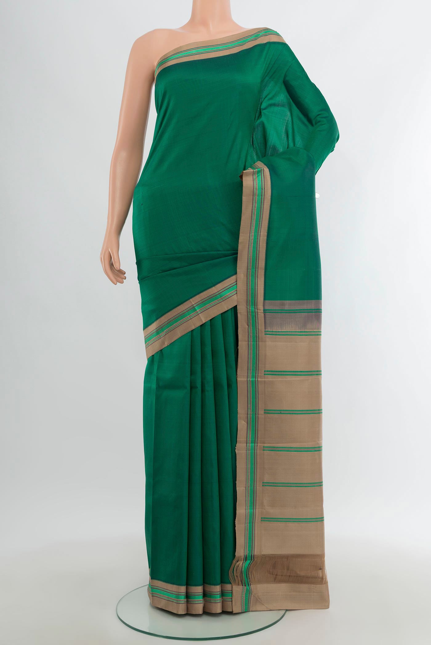 Bottle Green Kanjivaram Silk Saree with Plain Body and Thread Border.  displayed on a mannequin