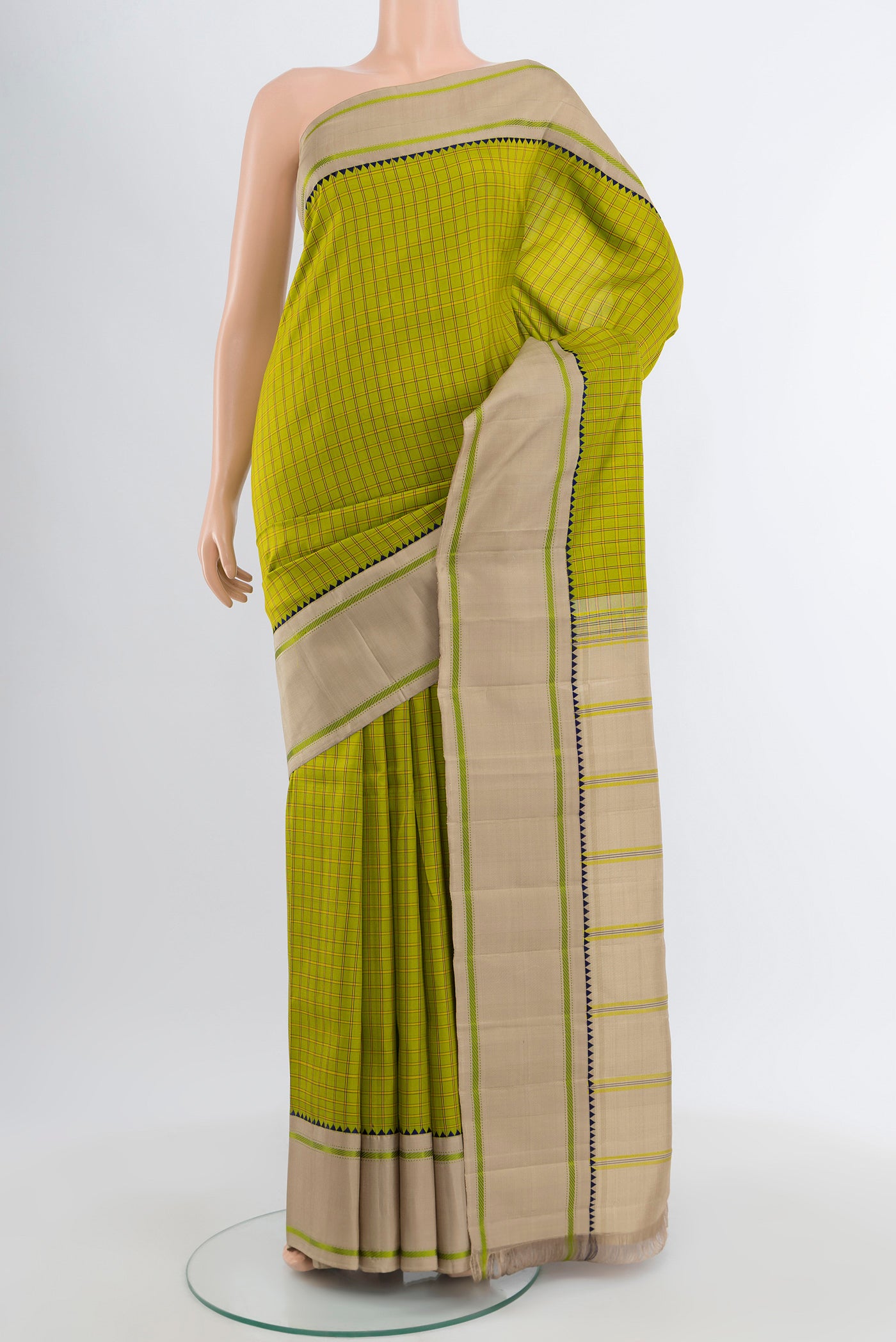 Light Green Kanjivaram Silk Saree with Checked design on the body and Plain Border.  displayed on a mannequin