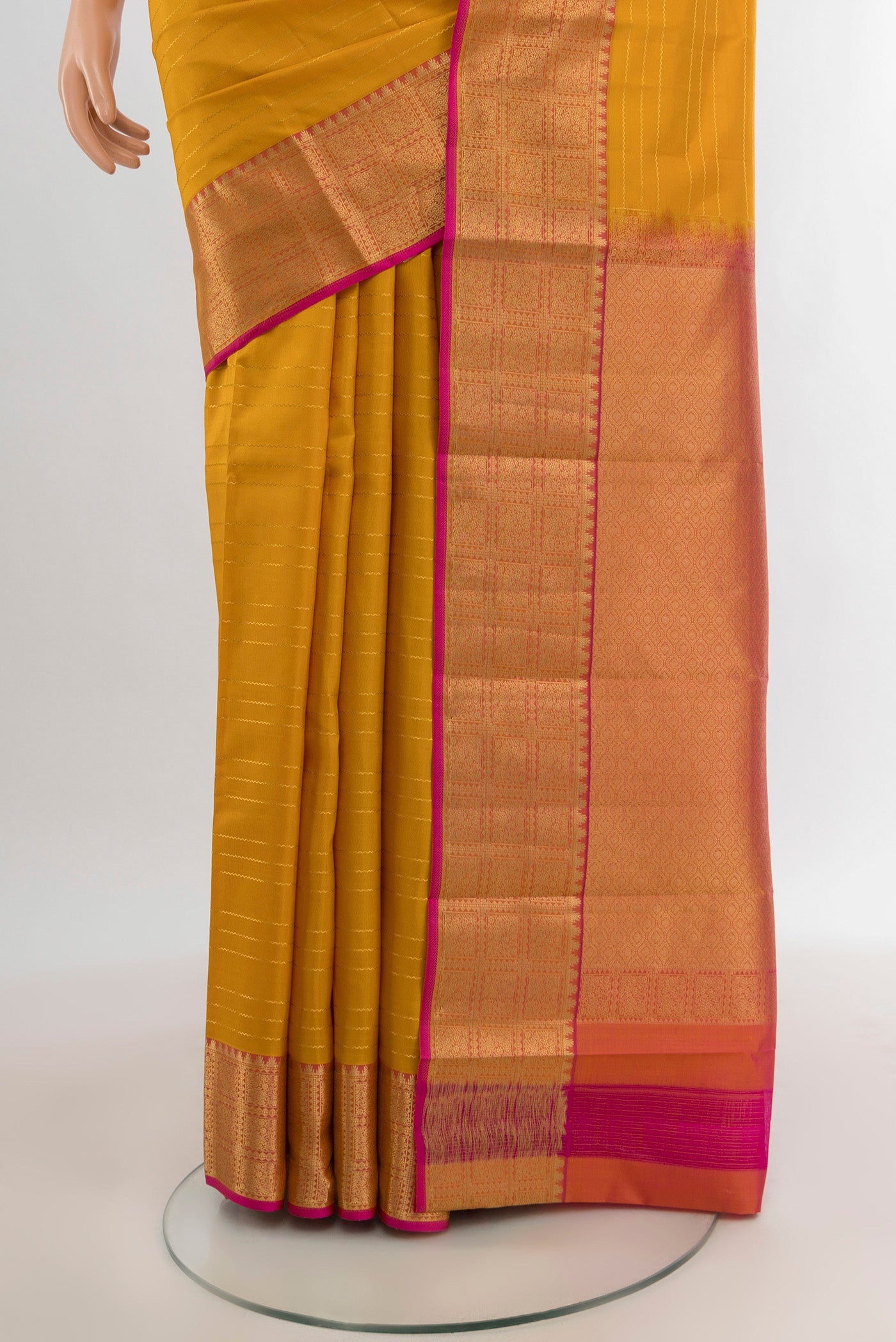 Pleats and pallu of Mustard Kanchipuram Silk Saree with Stripes on the body and Zari Border. 