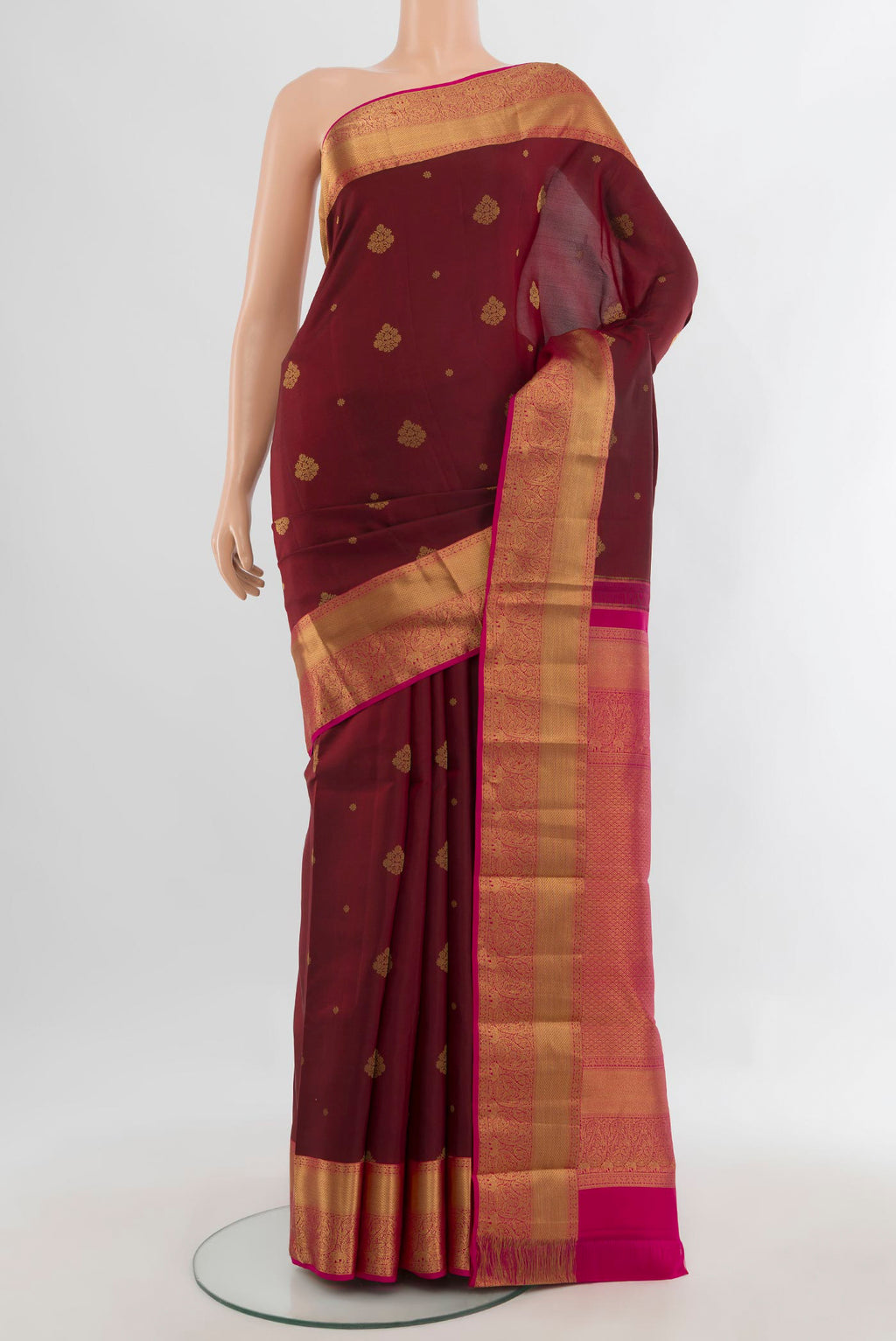 Pure Silk Maroon Kanjivaram Saree with Zari Butta on the body and Zari Border.  displayed on a mannequin