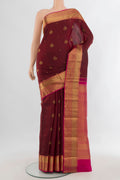 Pure Silk Maroon Kanjivaram Saree with Zari Butta on the body and Zari Border.  displayed on a mannequin