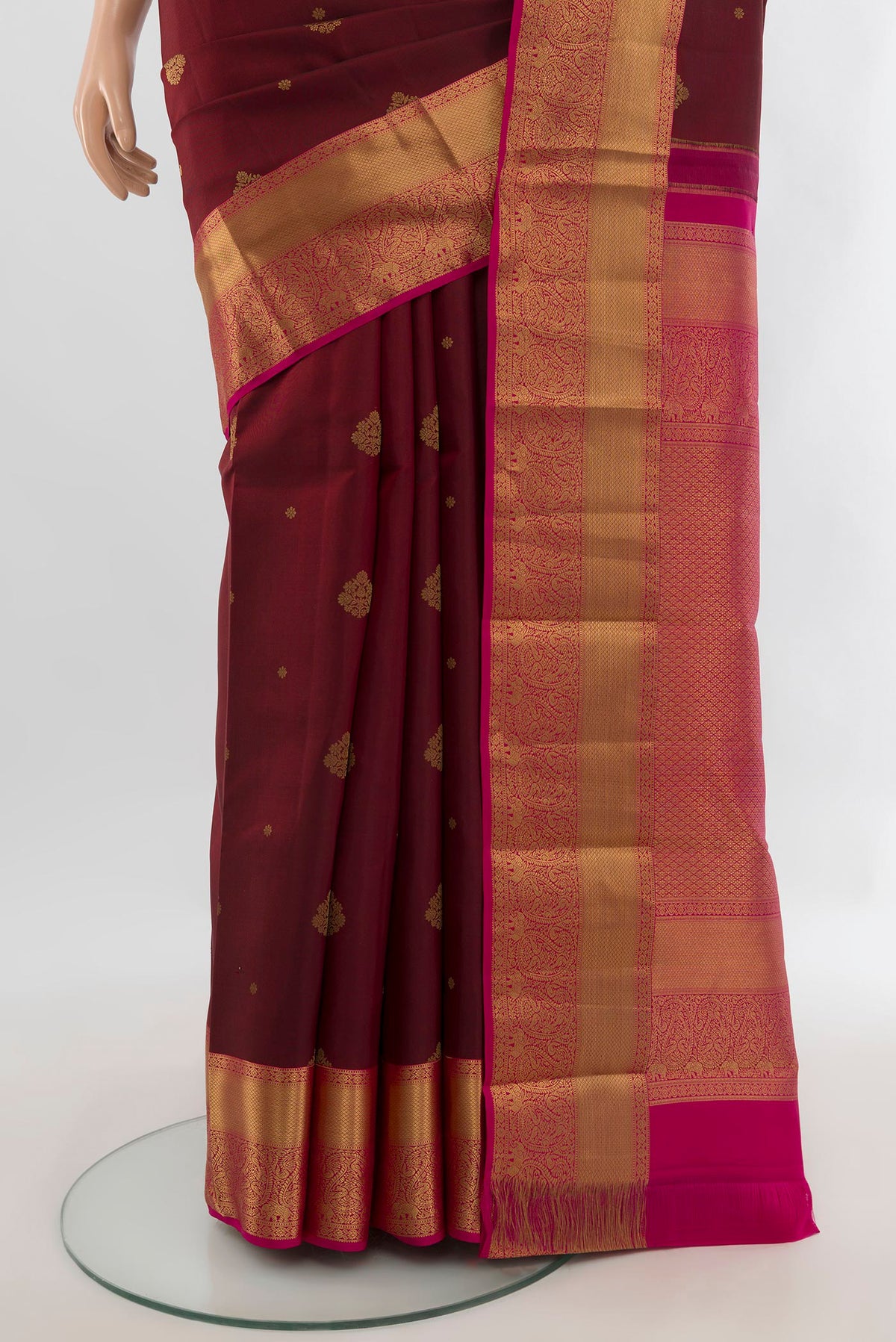 Pleats and pallu of Pure Silk Maroon Kanjivaram Saree with Zari Butta on the body and Zari Border. 