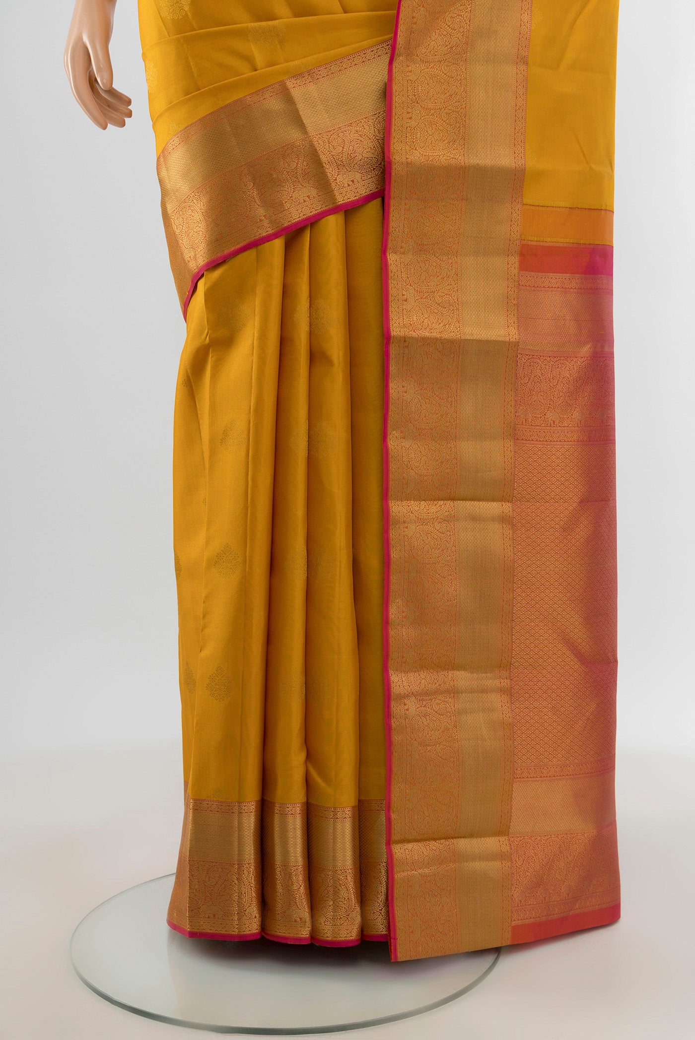 Pleats and pallu of Mustard Kanjivaram Silk Saree with Zari Butta on the body and Zari Border. 