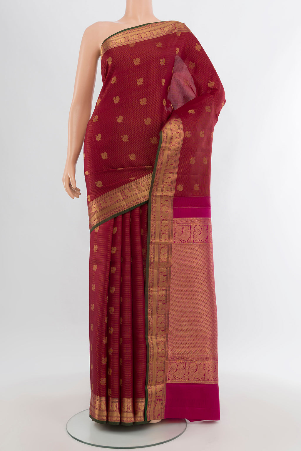 Maroon Kanchipuram Silk Saree with Zari Butta on the body and Zari Border.  displayed on a mannequin