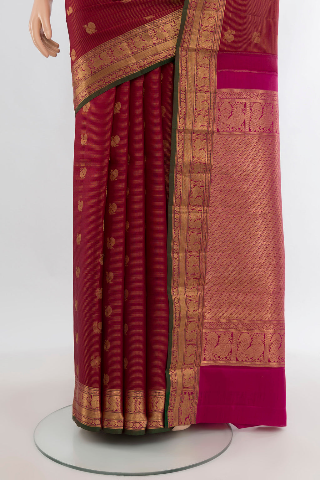 Pleats and pallu of Maroon Kanchipuram Silk Saree with Zari Butta on the body and Zari Border. 