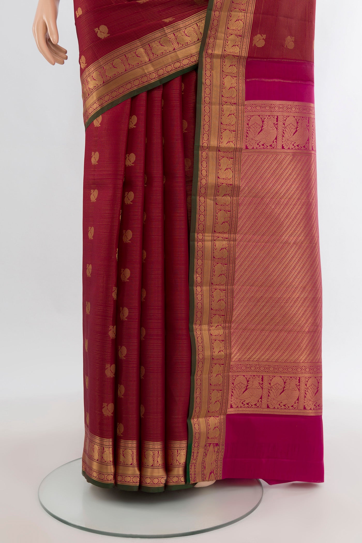 Pleats and pallu of Maroon Kanchipuram Silk Saree with Zari Butta on the body and Zari Border. 