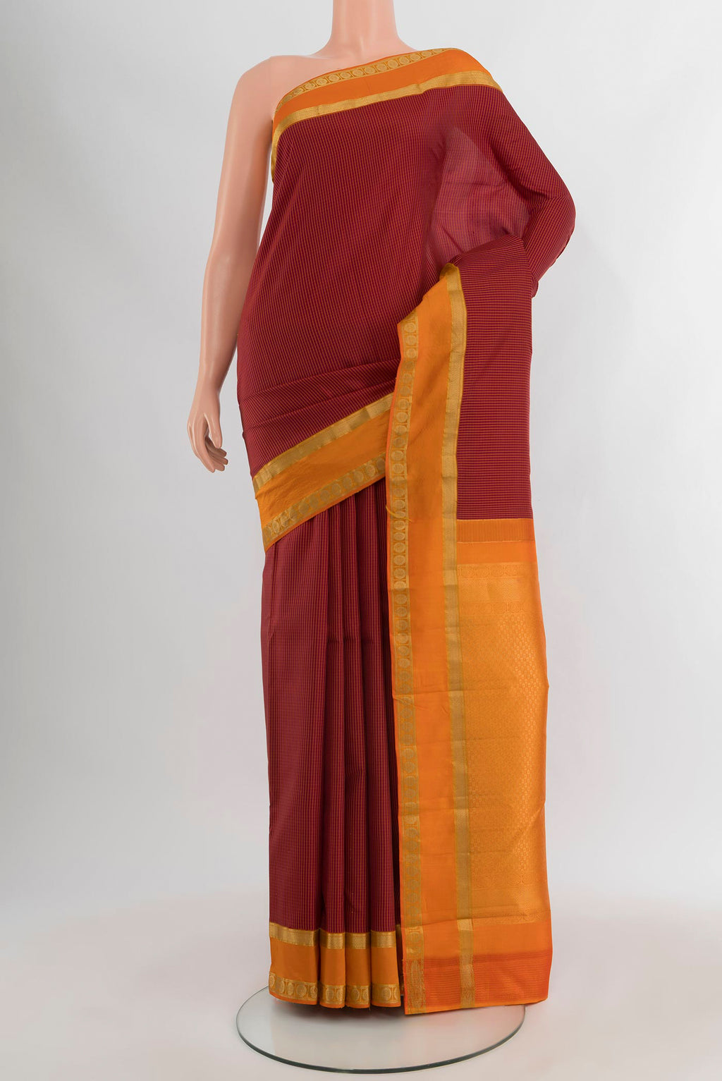 Maroon Kanjivaram Silk Saree with Stripes on the body and Zari Border.  displayed on a mannequin
