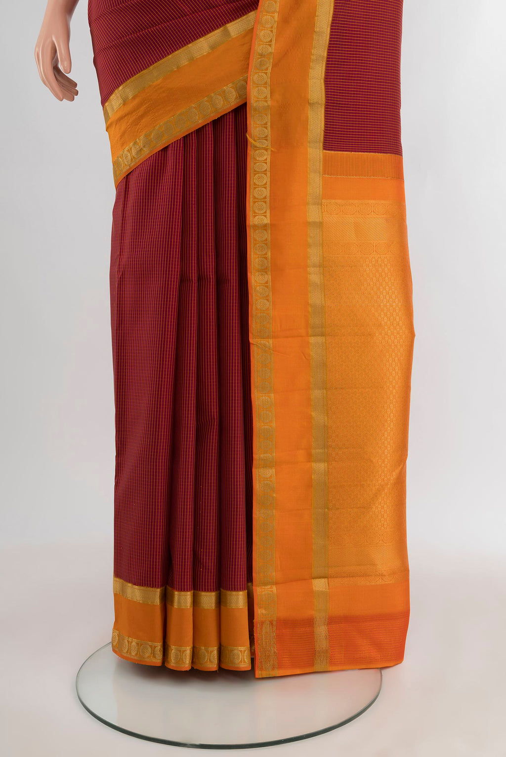 Pleats and pallu of Maroon Kanjivaram Silk Saree with Stripes on the body and Zari Border. 