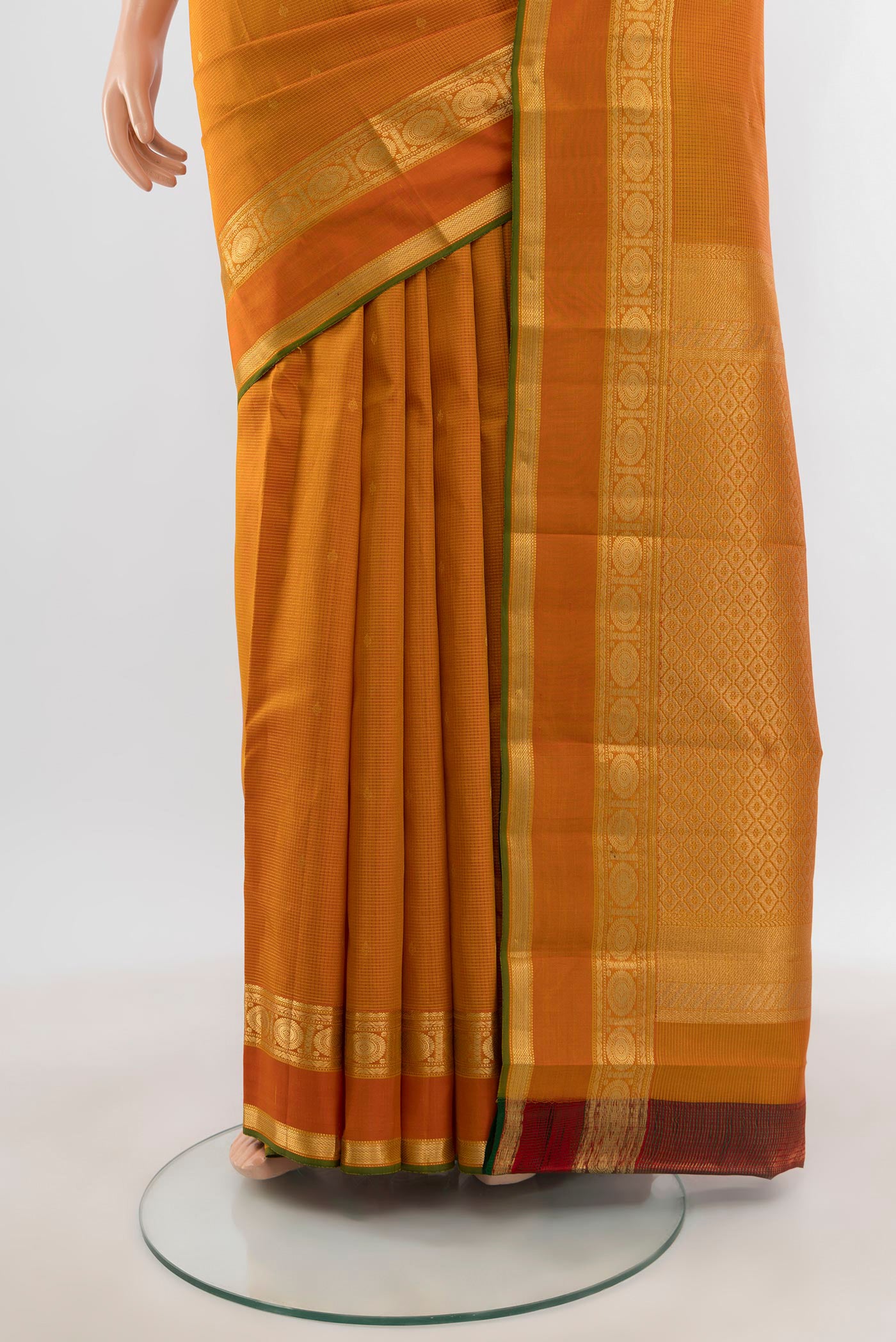 Pleats and pallu of Mustard Kanjivaram Silk Saree with Zari Butta on the body and Zari Border. 
