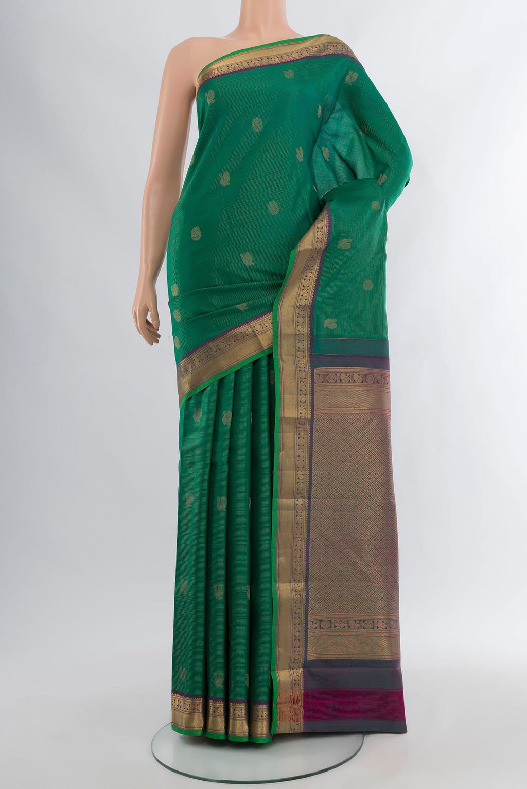 Green Kanchipuram Silk Saree with Zari Butta on the body and Zari Border.  displayed on a mannequin