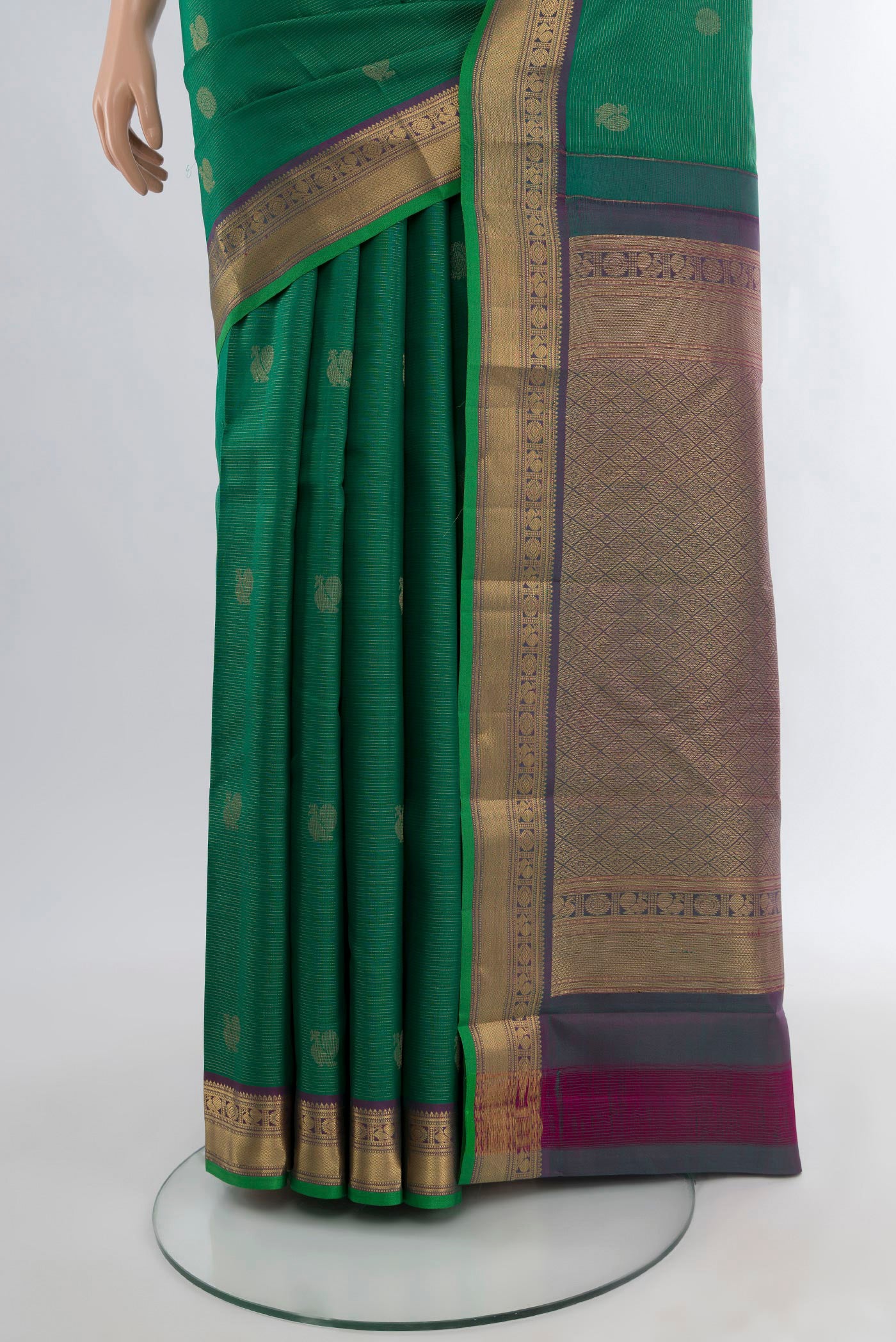 Pleats and pallu of Green Kanchipuram Silk Saree with Zari Butta on the body and Zari Border. 