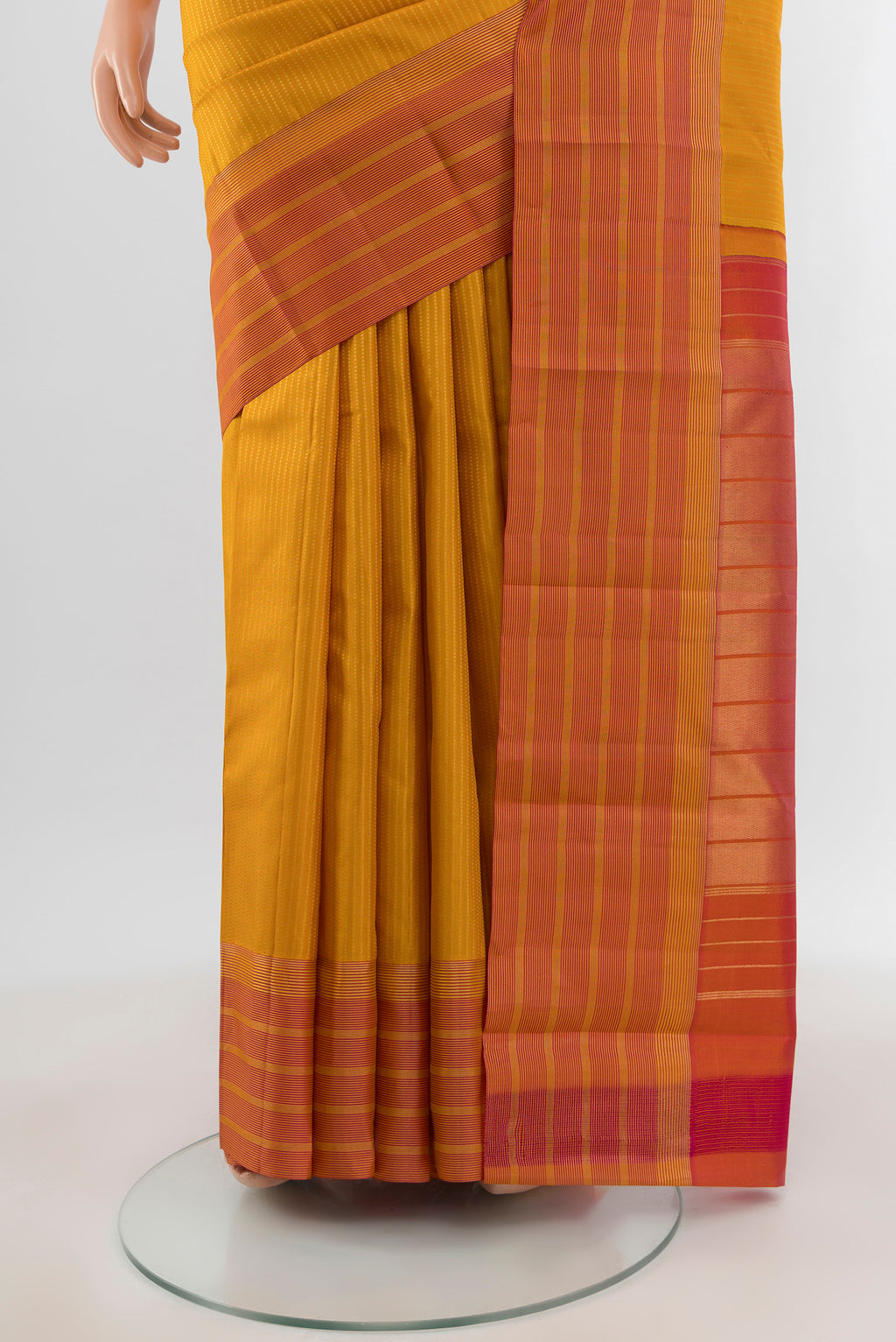 Pleats and pallu of Mustard Kanchipuram Silk Saree with Stripes on the body and Zari Border. 