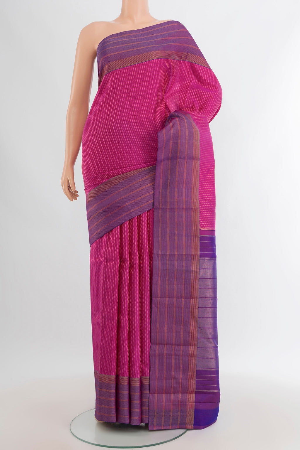 Magenta Kanchipuram Silk Saree with Stripes on the body and Zari Border.  displayed on a mannequin