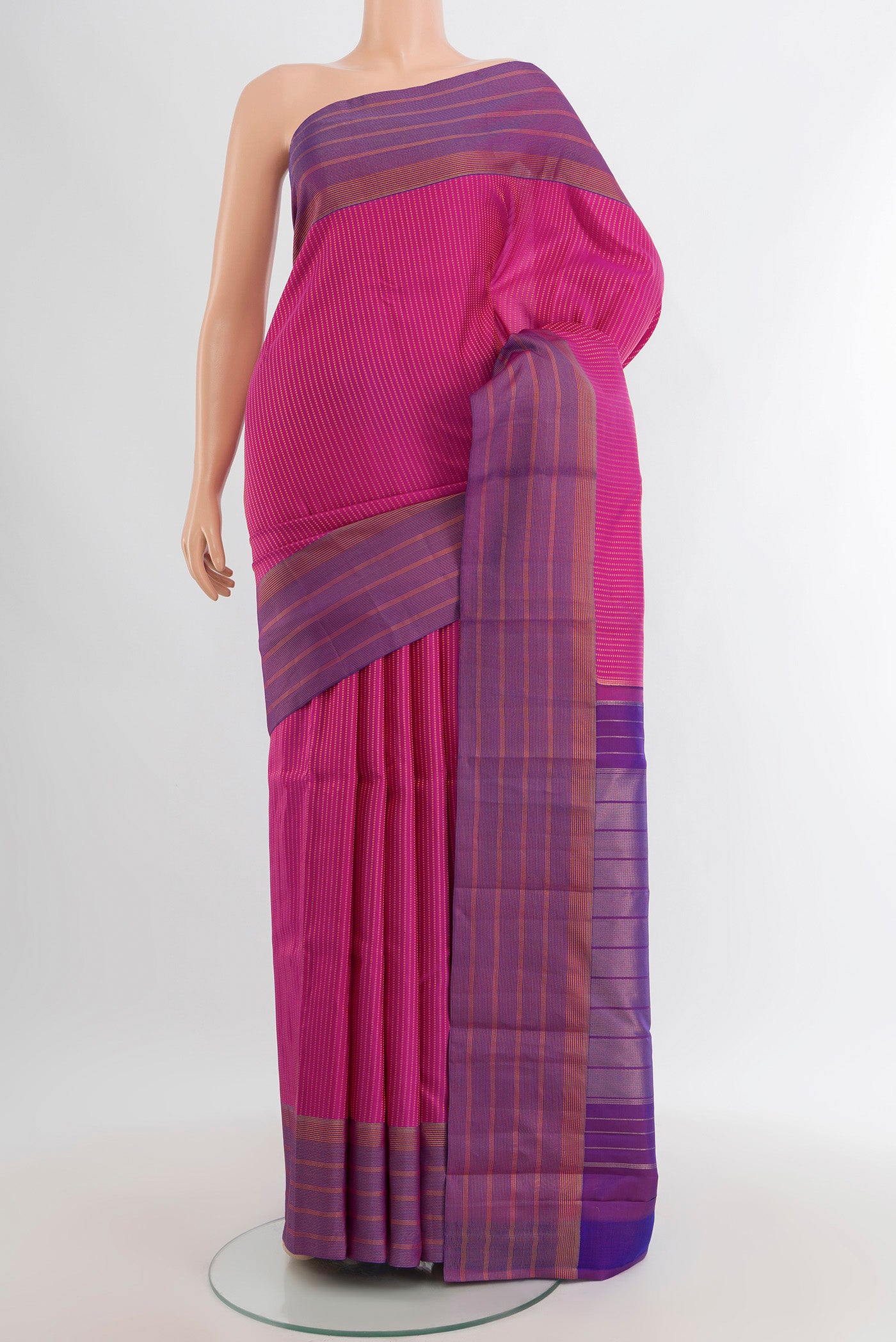 Magenta Kanchipuram Silk Saree with Stripes on the body and Zari Border.  displayed on a mannequin