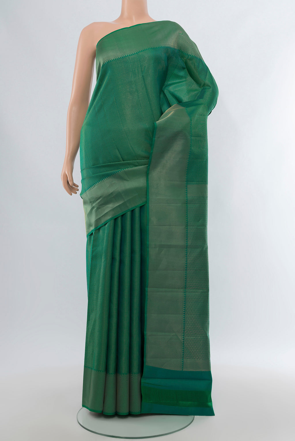 Green Kanchipuram Silk Saree with Checked design on the body and Zari Border.  displayed on a mannequin