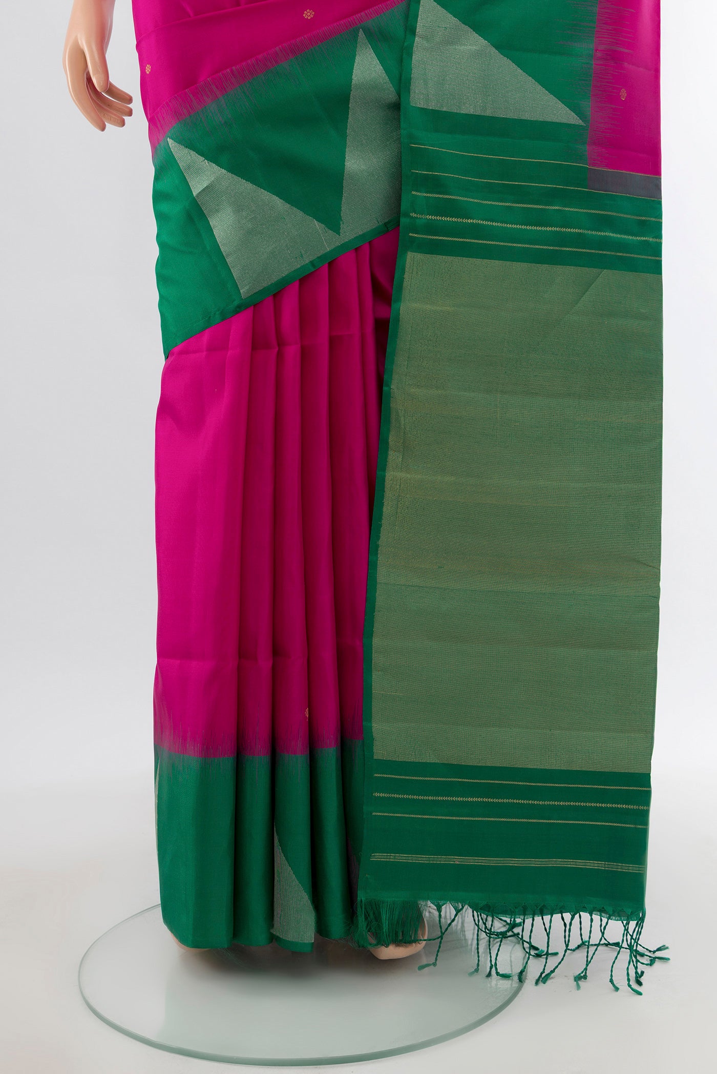 Pleats and pallu of Rani Pink Soft Silk Saree with Zari Butta on the body and Fancy Border. 