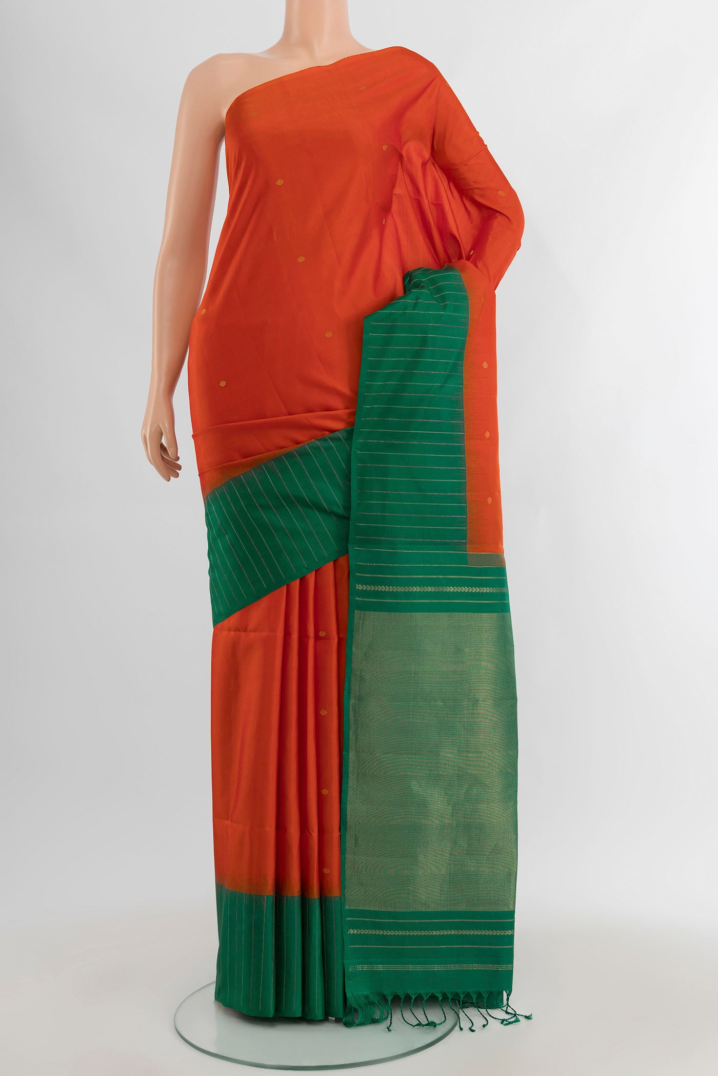 Orange Soft Silk Saree with Zari Butta on the body and Plain Border.  displayed on a mannequin