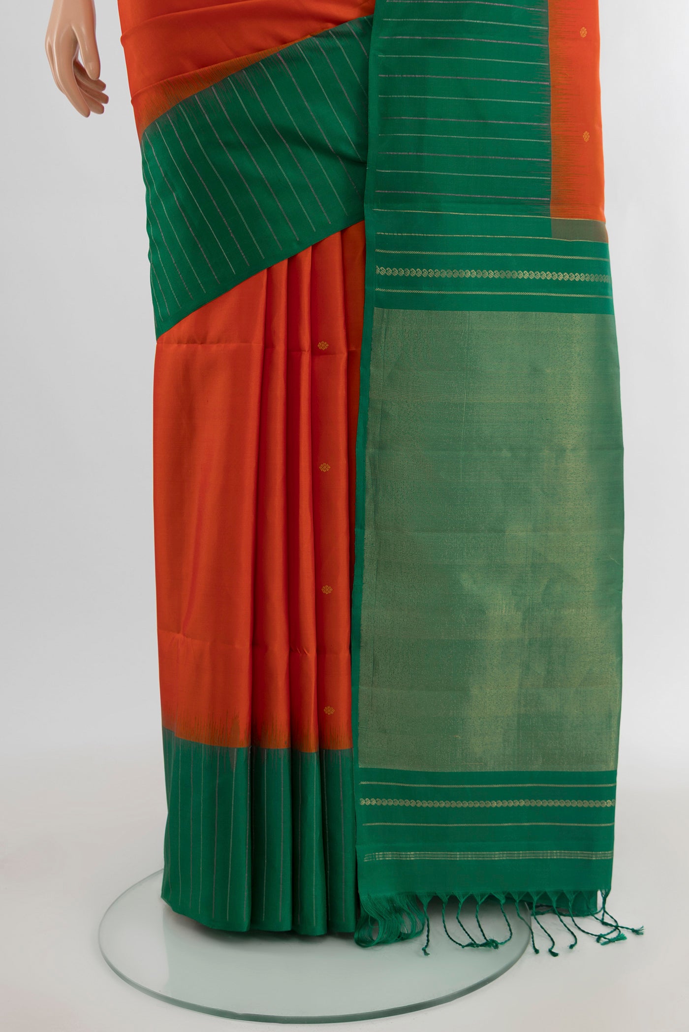 Pleats and pallu of Orange Soft Silk Saree with Zari Butta on the body and Plain Border. 