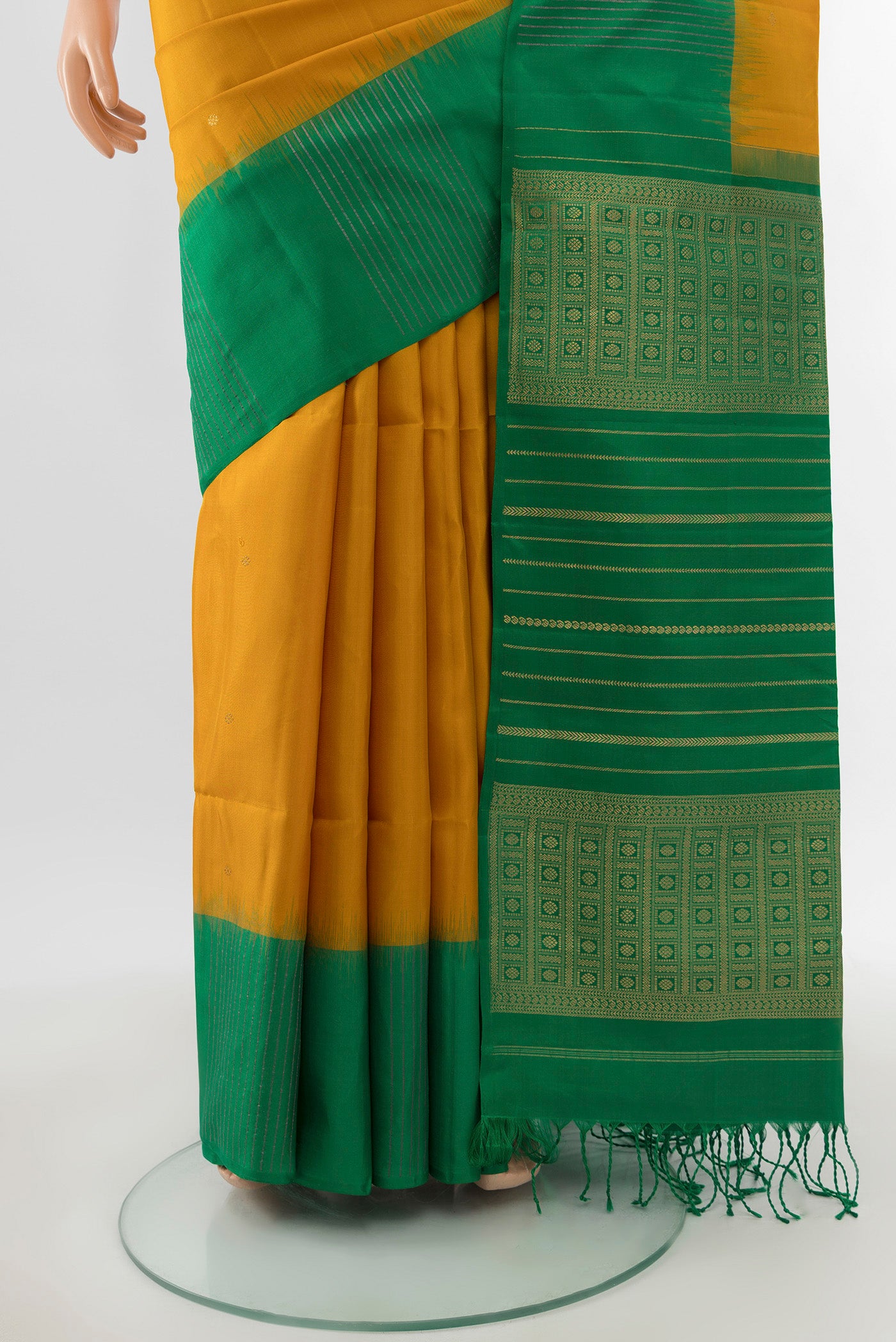 Pleats and pallu of Mustard Soft Silk Saree with Zari Butta on the body and Fancy Border. 