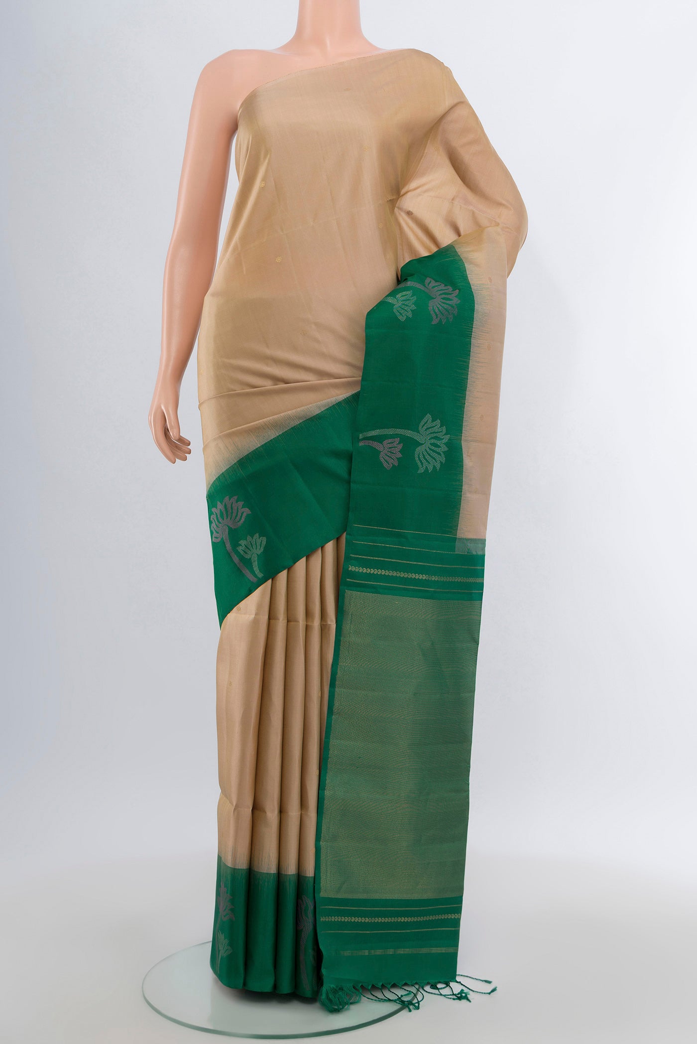 Dark Beige Soft Silk Saree with Zari Butta on the body and Fancy Border.  displayed on a mannequin