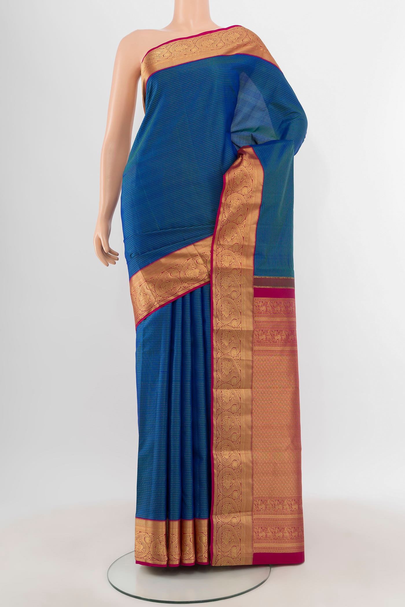 Blue Kanchipuram Silk Saree with Zari Butta on the body and Zari Border.  displayed on a mannequin