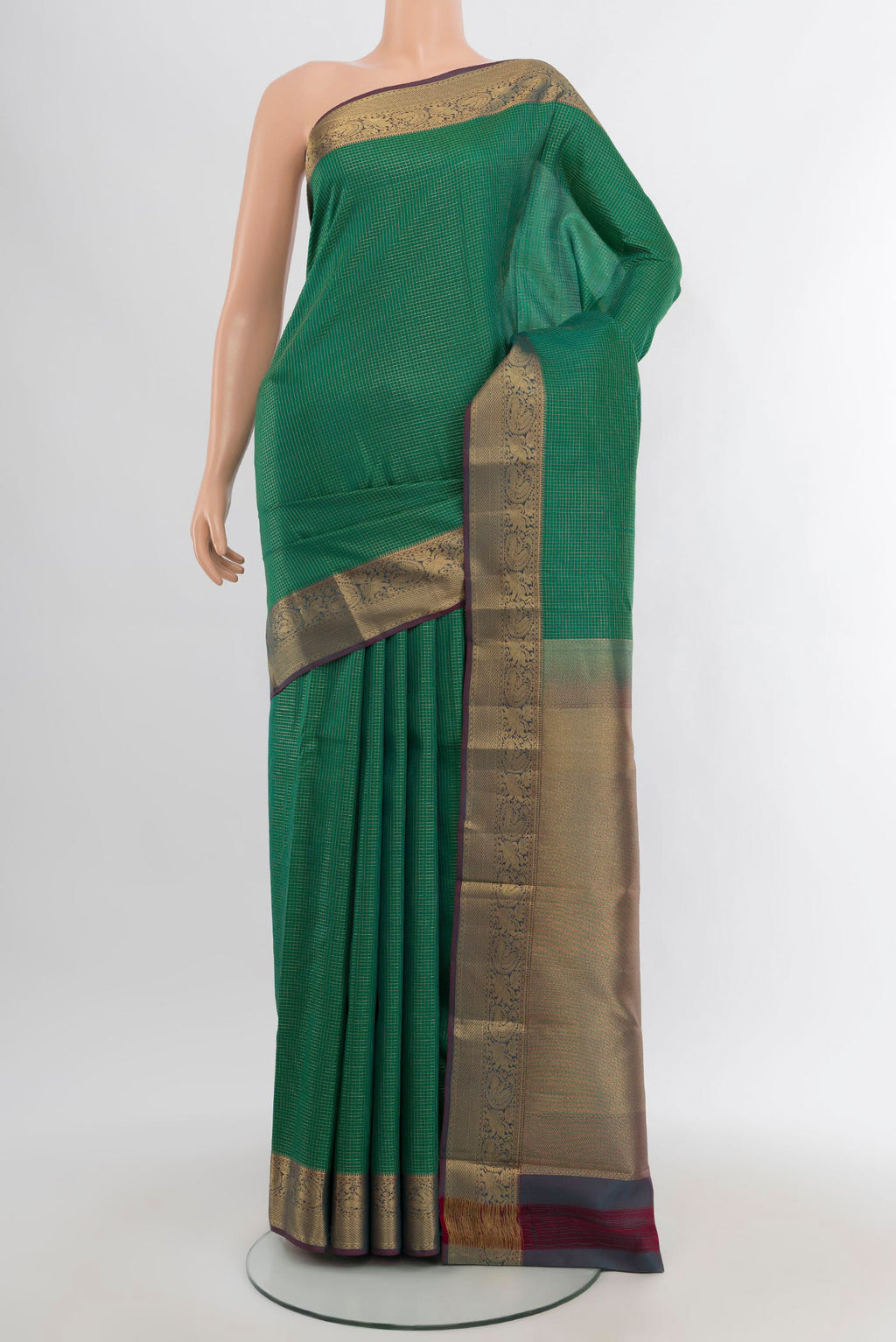 Green Kanchipuram Silk Saree with Checked design on the body and Zari Border.  displayed on a mannequin