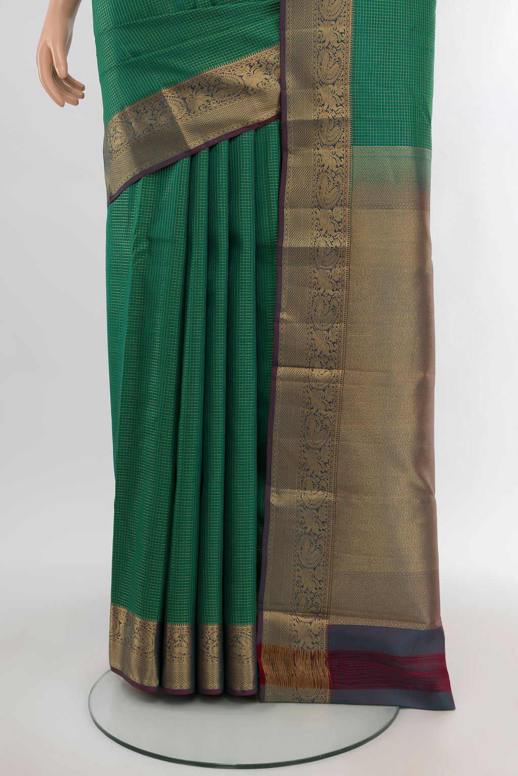Pleats and pallu of Green Kanchipuram Silk Saree with Checked design on the body and Zari Border. 