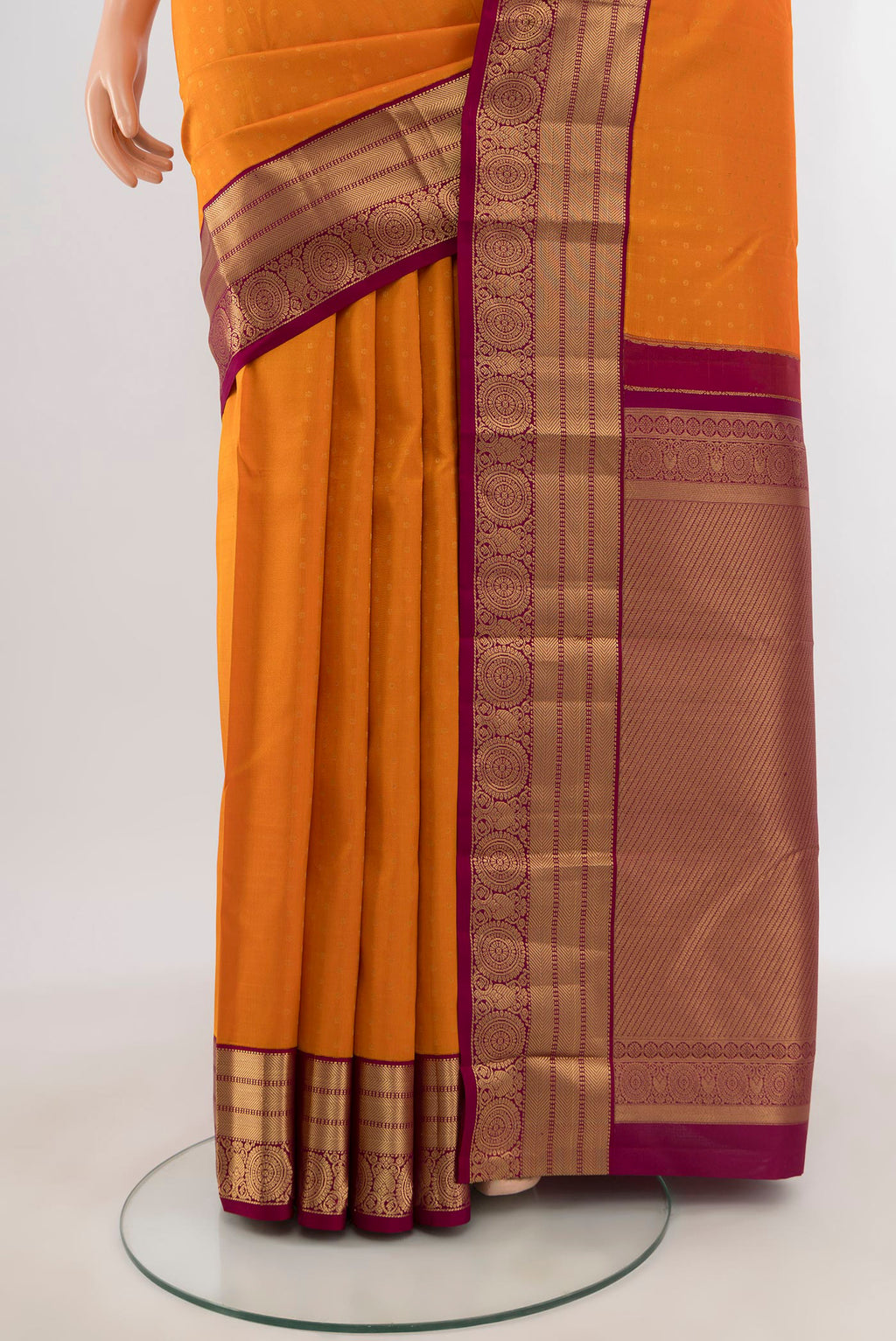 Pleats and pallu of Orange Kanchipuram Silk Saree with Zari Butta on the body and Zari Border. 