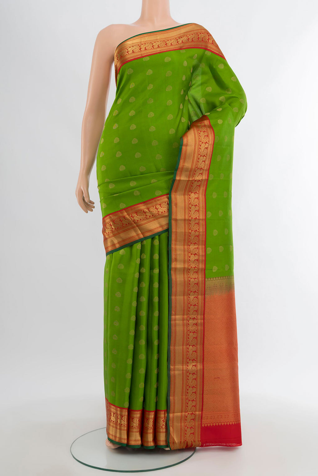 Green Kanchipuram Silk Saree with Zari Butta on the body and Zari Border.  displayed on a mannequin