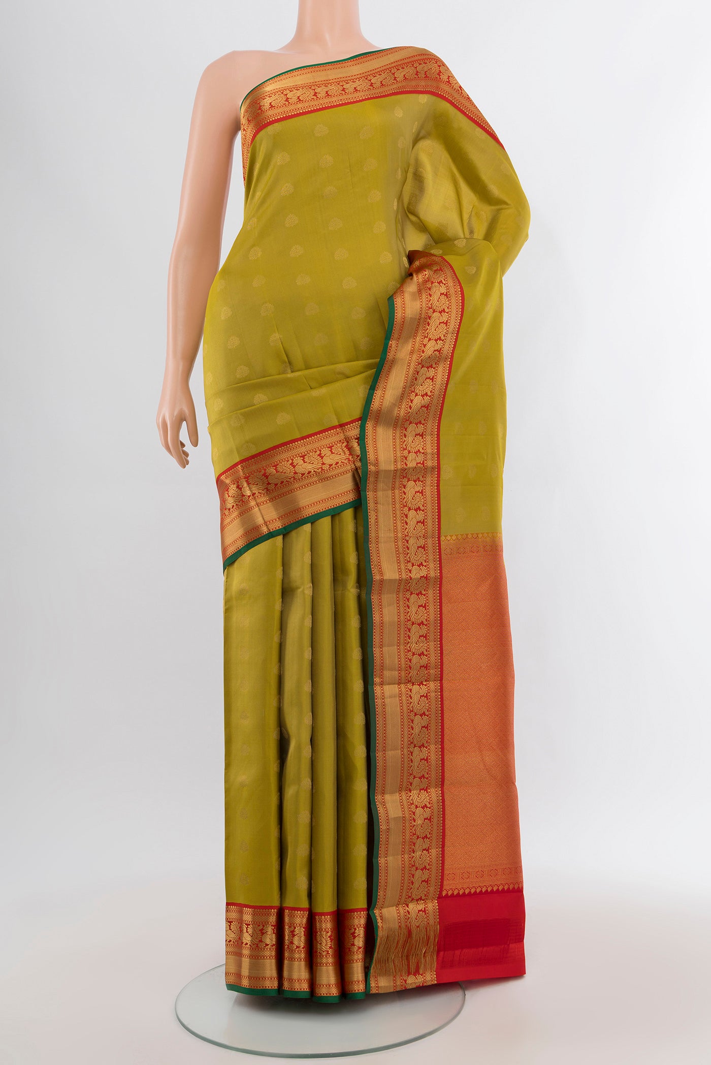 Green Kanchipuram Silk Saree with Zari Butta on the body and Zari Border.  displayed on a mannequin