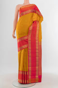 Mustard Kanchipuram Silk Saree with Checked design on the body and Zari Border.  displayed on a mannequin
