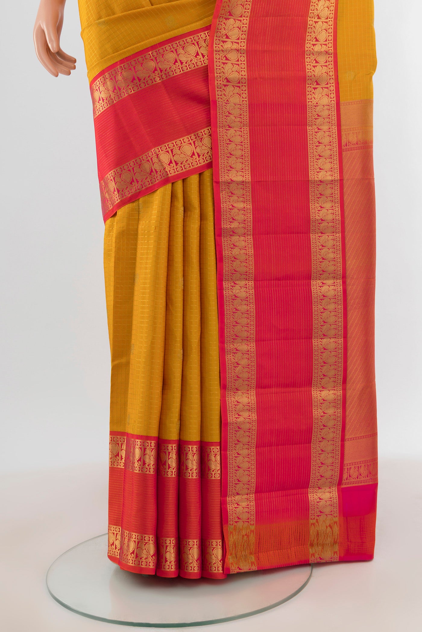 Pleats and pallu of Mustard Kanchipuram Silk Saree with Checked design on the body and Zari Border. 