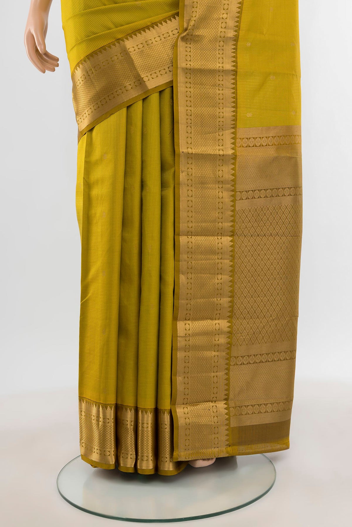 Pleats and pallu of Mehandi Green Kanjivaram Silk Saree with Zari Butta on the body and Zari Border. 