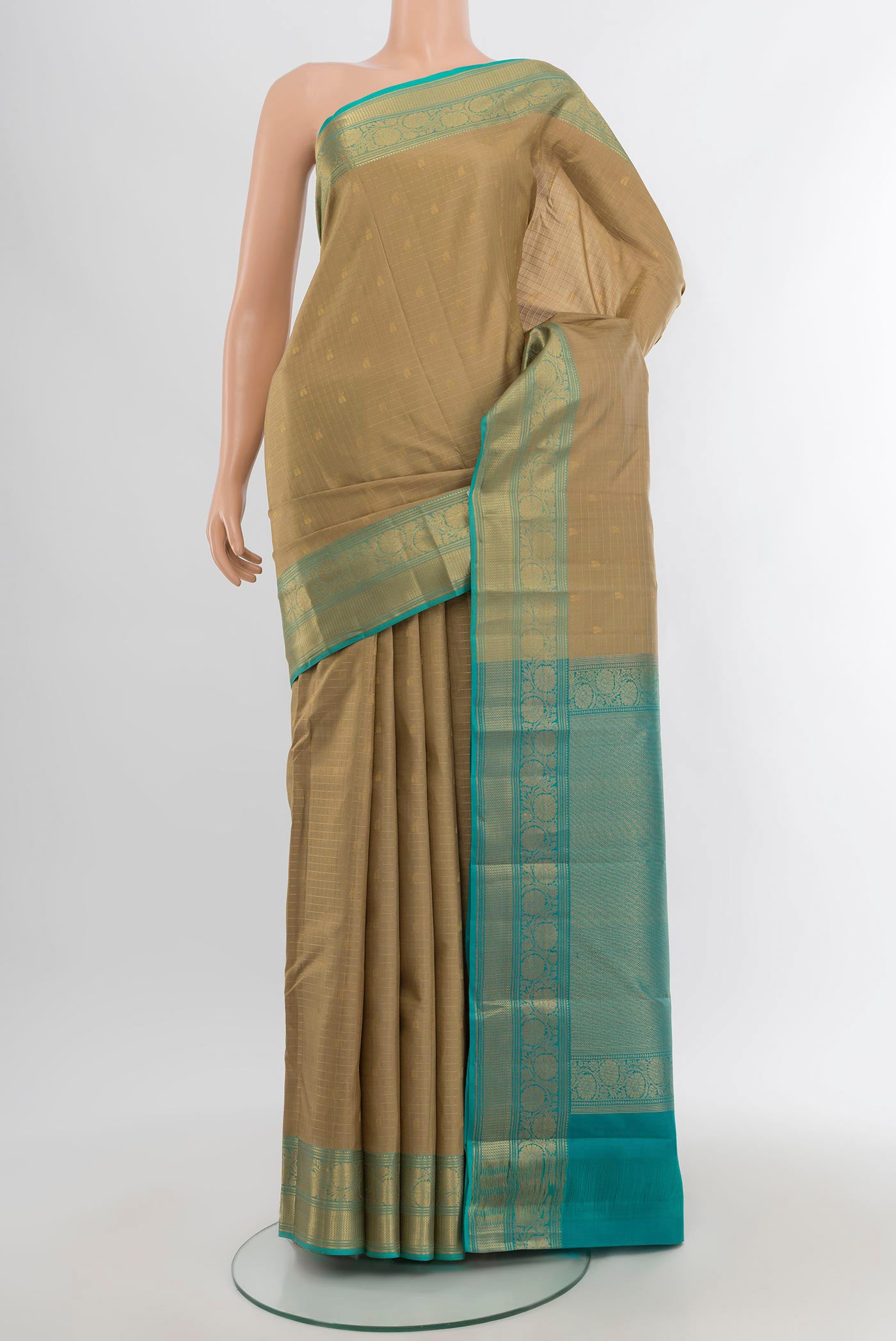 Beige Kanchipuram Silk Saree with Checked design on the body and Zari Border.  displayed on a mannequin
