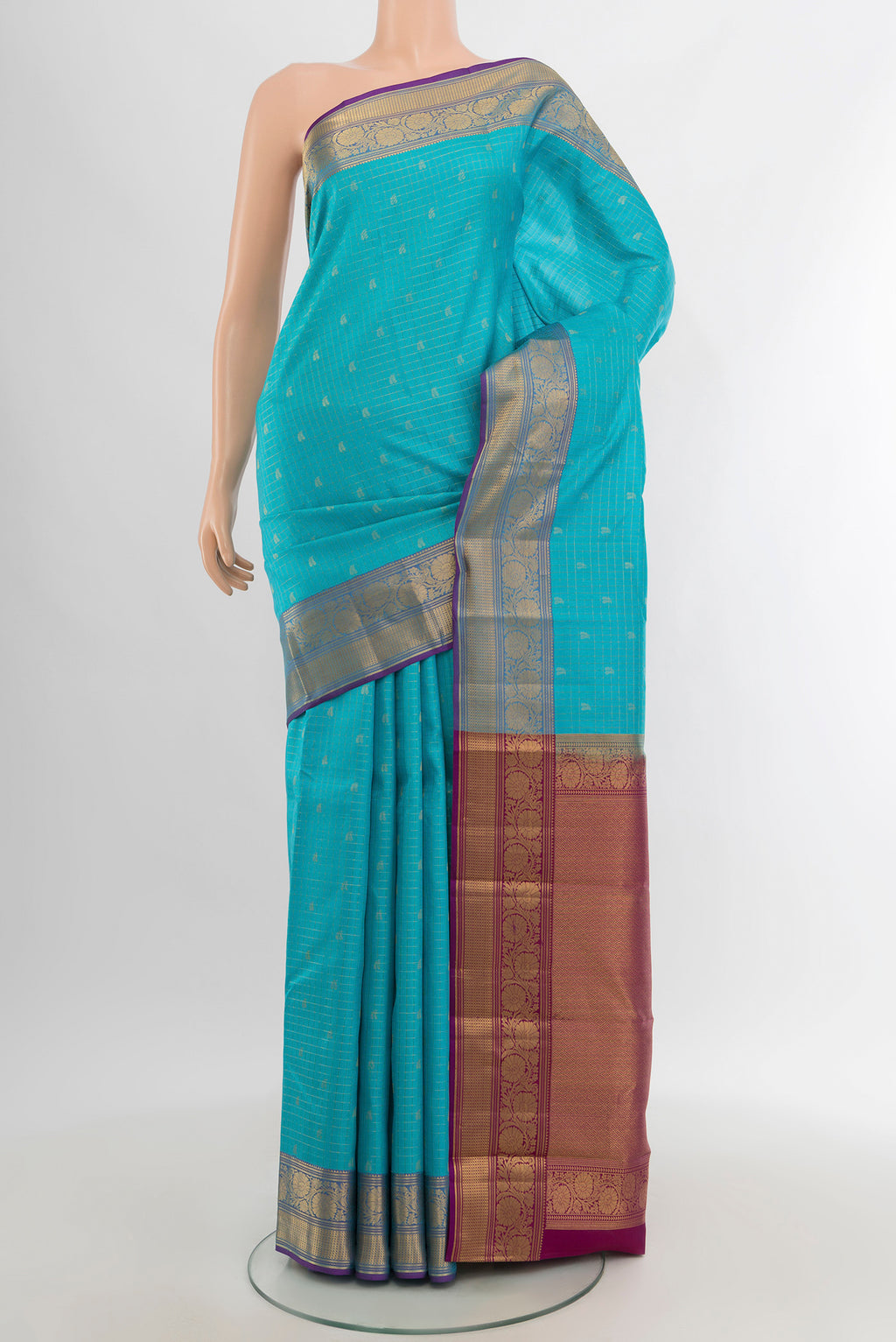 Sky Blue Kanchipuram Silk Saree with Zari Butta on the body and Zari Border.  displayed on a mannequin