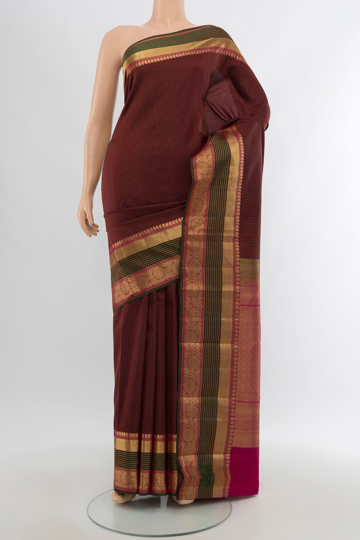 Maroon Kanjivaram Silk Saree with Zari Butta on the body and Zari Border.  displayed on a mannequin