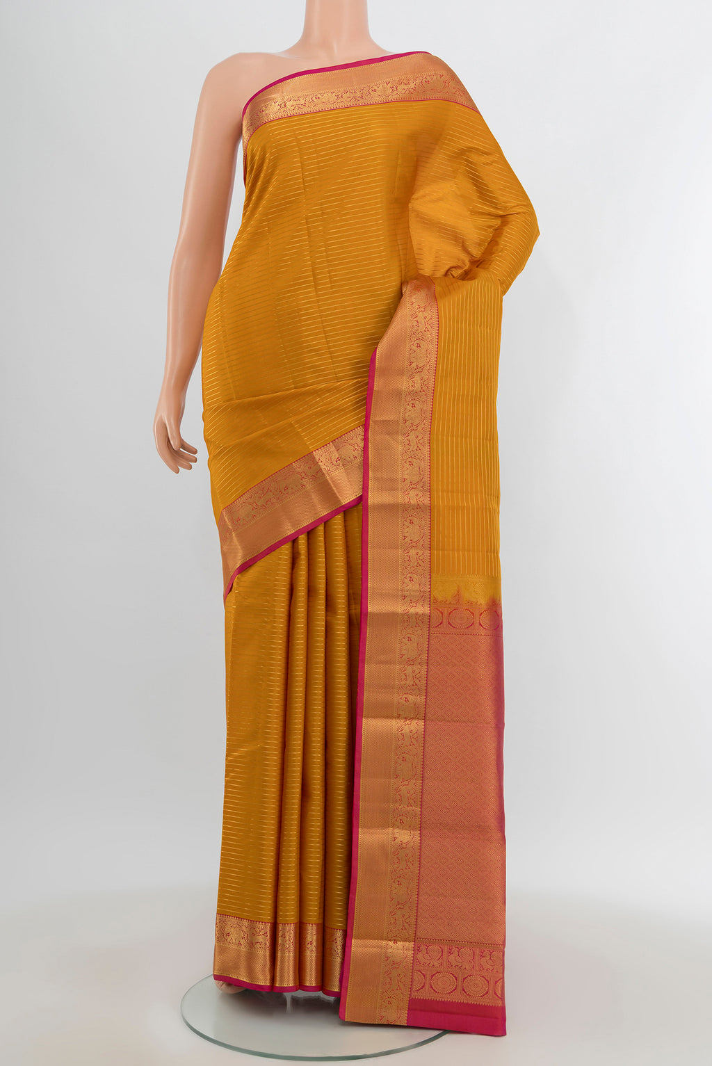 Mustard Kanjivaram Silk Saree with Stripes on the body and Zari Border.  displayed on a mannequin