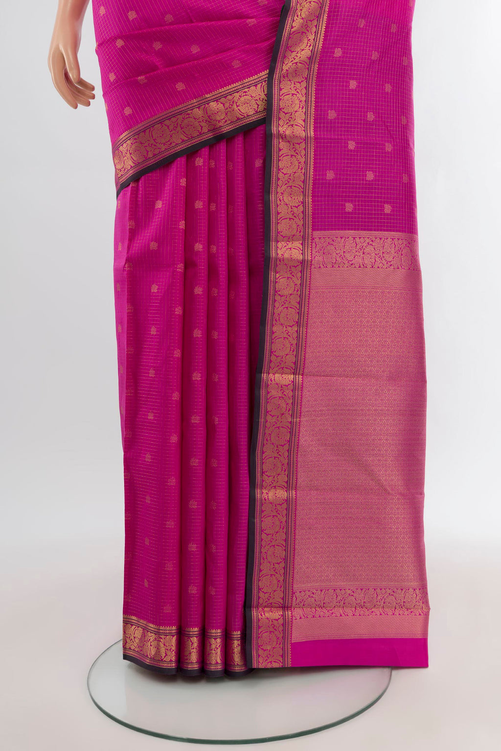 Pleats and pallu of Rani Pink Kanchipuram Silk Saree with Zari Butta on the body and Zari Border. 