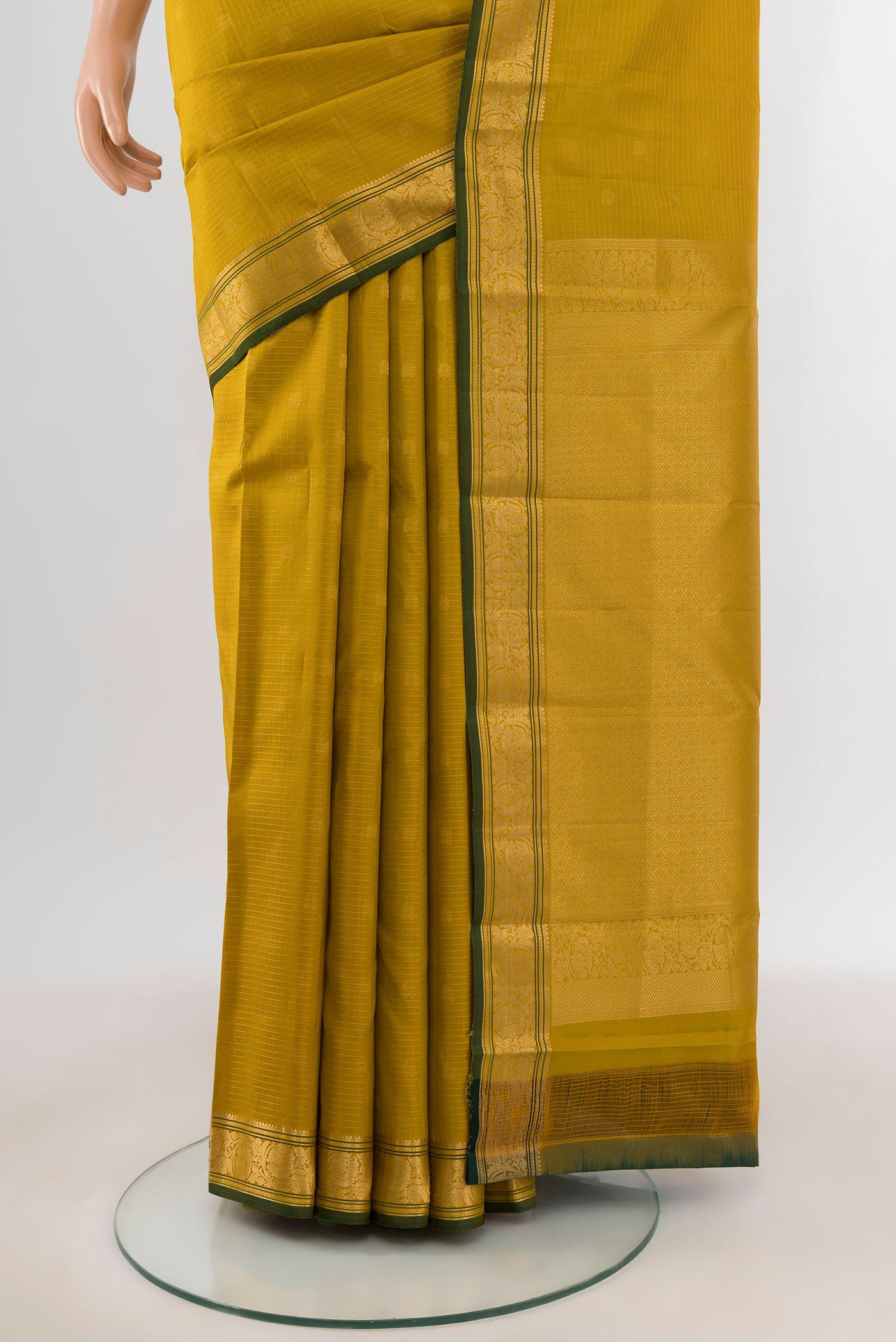Pleats and pallu of Mehandi Green Kanchipuram Silk Saree with Zari Butta on the body and Zari Border. 