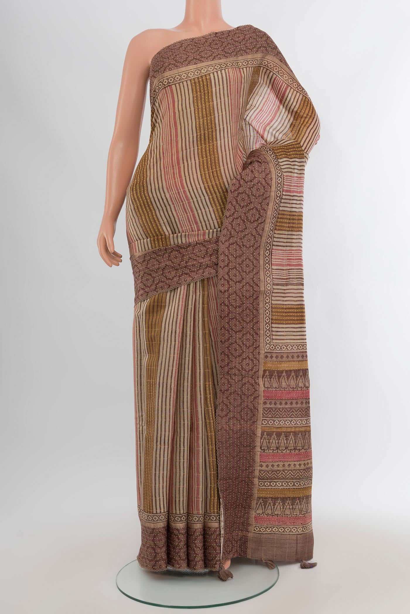 Brown Tussar Silk Saree with Printed design on the body and Printed Border.  displayed on a mannequin