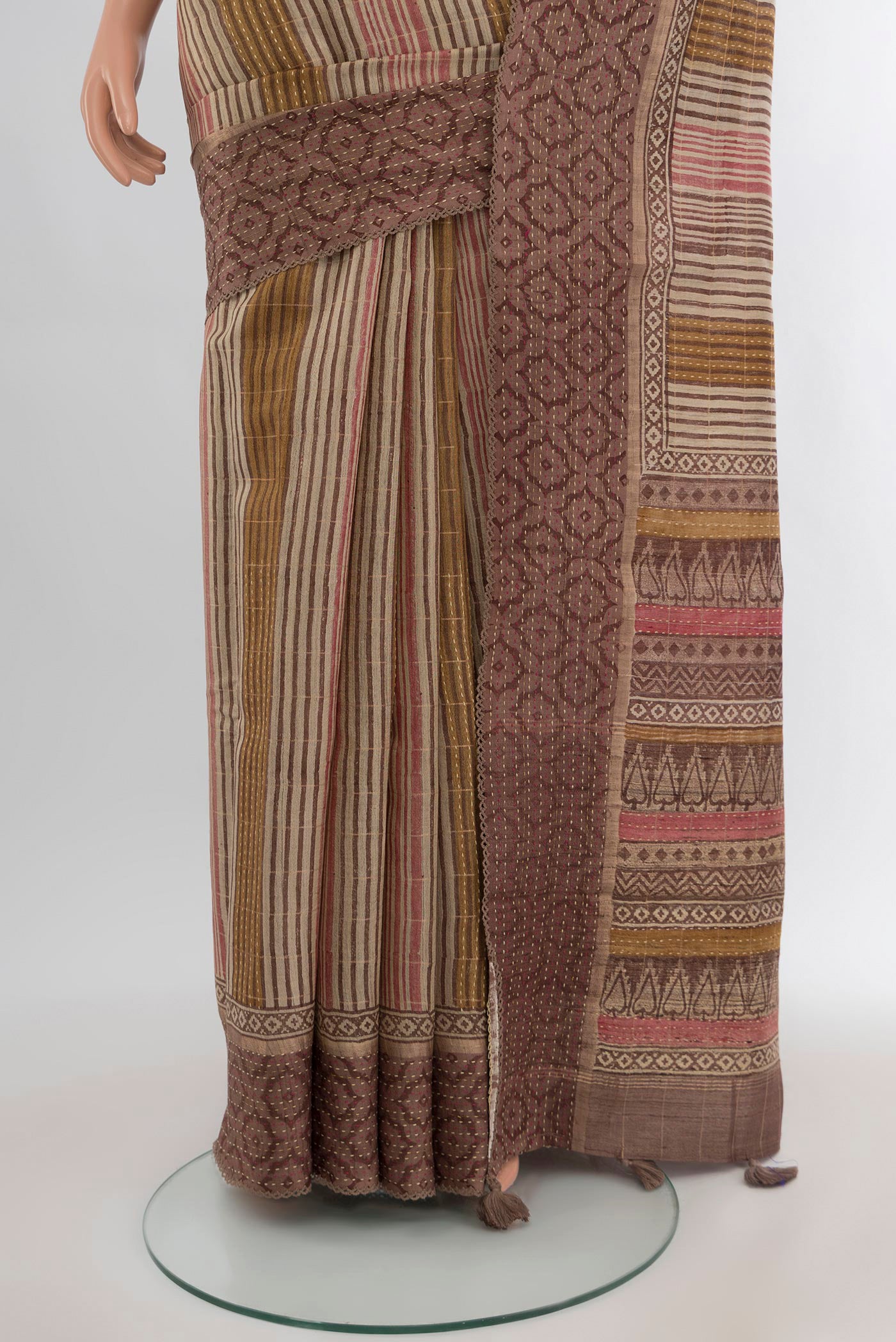 Pleats and pallu of Brown Tussar Silk Saree with Printed design on the body and Printed Border. 